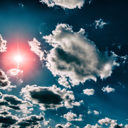 Sun and blue sky with clouds. Early spring, March.