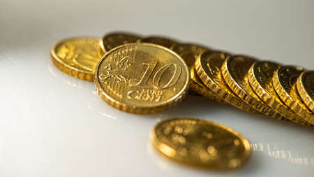 Coin ten euro cents and a stack of coins lies on the surface of the table. Web banner. Business concept.の写真素材