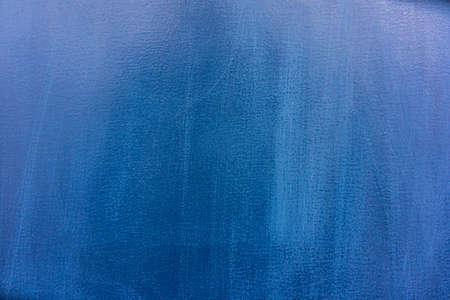 Metal sheet painted with old blue paint, scratched surface. Background for design.