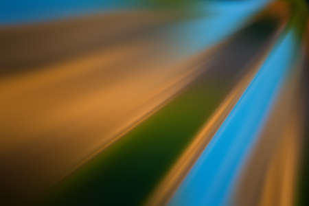 radial diagonal multicolored light rays, blurred background. Abstract background for design.の写真素材