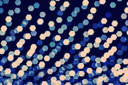 Abstract blurry pink and blue light hexagonal spots on a dark background. Background for design.