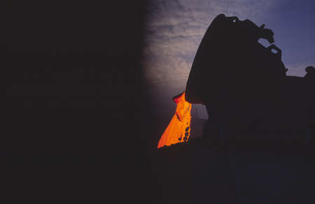 Discharge of metallurgical slag at night, storage of metallurgical waste. Metal production.の写真素材