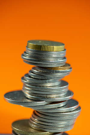 stack of Swiss  coins on an orange background. Business concept.の写真素材