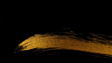 Trace of golden paint with a brush on a black background. For design. Web banner.
