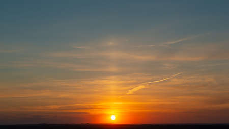 Sunset over the hills in the countryside. Spring evening. Web banner.の写真素材