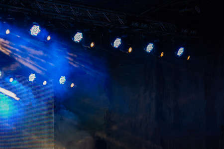 Stage lighting during a rock music concert and dark background of the stage. Web banner. For design.