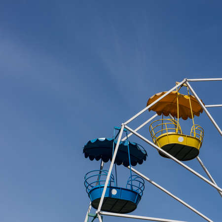 Ferris wheel against the blue sky on a sunny day in the park. Spring season, May.の写真素材