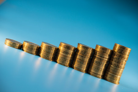Stacks of coins ascending on a light blue background. Business concept. Web banner.の写真素材