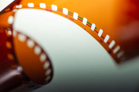 Photographic film negative rolled up roll on a light background. Web banner.の写真素材