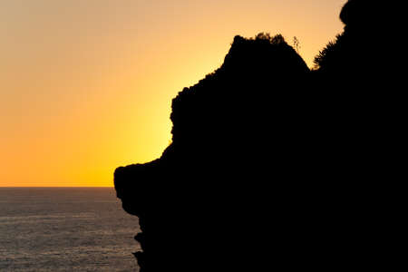 Beautiful sunset behind the mountain at the sea coast