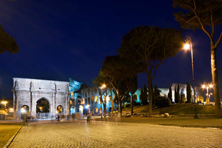 The Colosseum and the Arch of Constantine at nightの写真素材