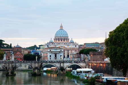 Evening view at the Angelo bridge and St. Peter's Basilica in Rome, Italyの写真素材