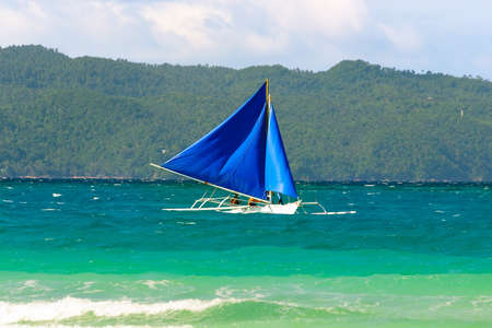 Blue sail boat on the seaの写真素材