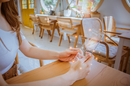 Beautiful woman using future smart phone virtual touch screen for order online shopping product. Multimedia Technology. Concept of Digital Future, food delivery, money wallet & online payment.の写真素材