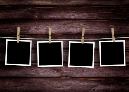 Old wooden polaroid film blanks hanging on a rope held by clothespins\rHistorical woodenpolaroid photo concept.の写真素材