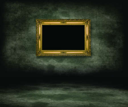 An empty dark dungeon wall.Golden picture frame on wallの写真素材