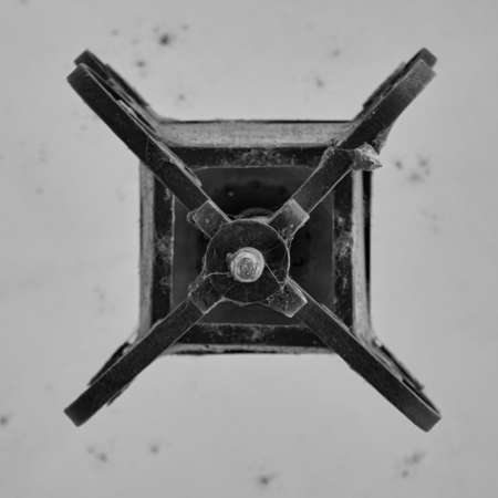 black and white detail of the bottom of old metal forged ceiling lantern