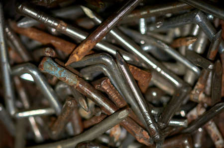 detail of a set set of old and rusty hook nails
