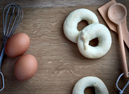 detail of pastry utensils, spoons, pastry beater, with some eggs, and anisette rolls on a kitchen...