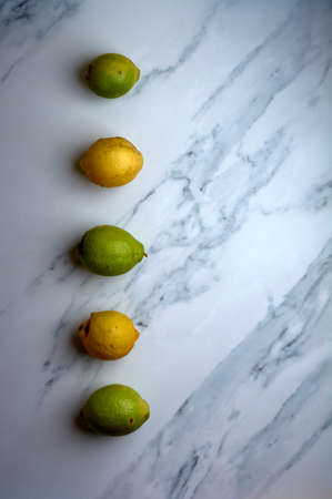 set of lemons on a white marble backgroundの写真素材
