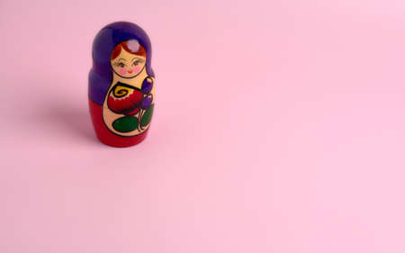 detail of matryoshka dolls of various colors on a smooth pink backgroundの写真素材