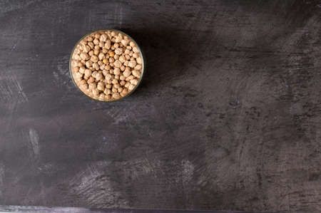 detail of a glass jar with chickpeas inside it on a dark backgroundの写真素材