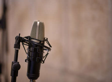 detail of a condenser microphone and stand on a beige backgroundの写真素材