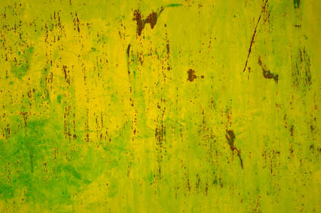 detail of a green painted and rusted sheet metal plate