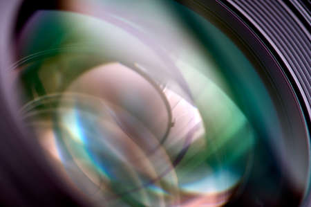 detail of green and violet reflections on the front of a photographic lensの写真素材