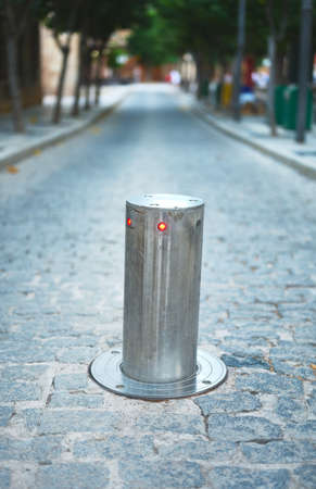 detail of an elevating pylon with luminous sign that closes a street