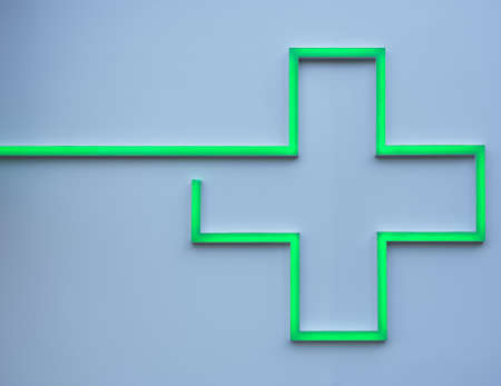 detail of green led cross on a pharmacy wall