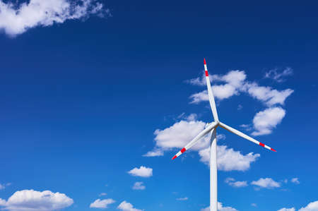 detail of a modern windmill on a blue day with clouds