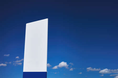 detail of a plastic milestone over a blue cloudy skyの写真素材
