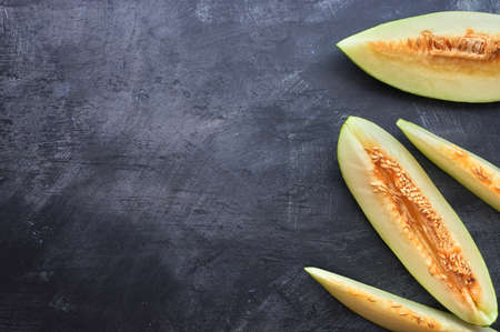 detail of a sliced melon on a dark background