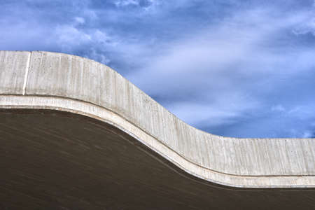 detail of the roof of a modern concrete building with blue sky in the backgroundの写真素材