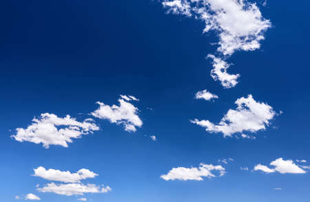 detail of a blue sky with white cloudsの写真素材