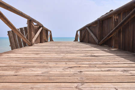 detail of a wooden walkway to the sea between the dunesの写真素材