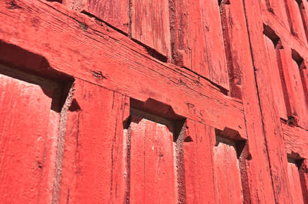 detail of a very deteriorated red wooden door