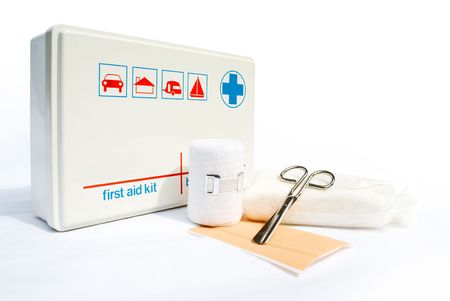 First aid kit with bandages and scissors on white background の写真素材