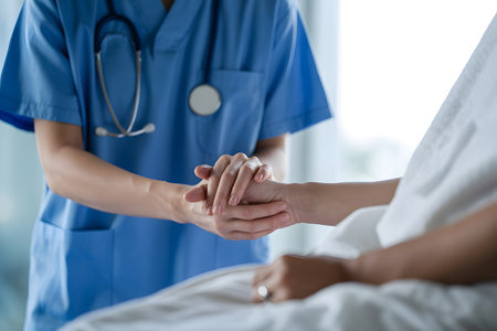 Compassionate Care: A healthcare professional in blue scrubs comforts a patient in a bright, clinical setting, captured in a moment of connection and trust.の素材