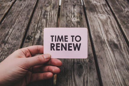 Neon sign reading 'Time to Renew!' in pink and blue against a dark brick wall, showcasing modern urban aesthetics with vibrant glowing effects.の素材