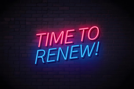 Close-up of a hand holding a light pink card with âTIME TO RENEWâ text, against a rustic wooden background with rich textures and tones.の素材