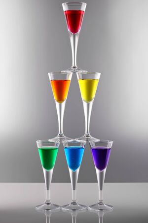 A row of drinks in rainbow coloursの写真素材