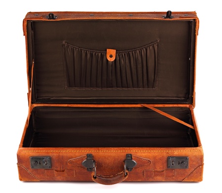An old leather opened suitcase on white backgroundの写真素材