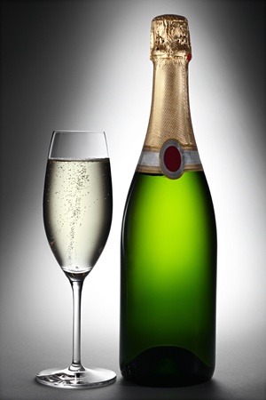 champagne bottle and glass in spotlightの写真素材