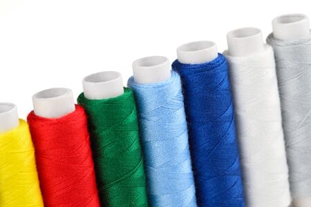 a row of yarn bobbins in closeupの写真素材