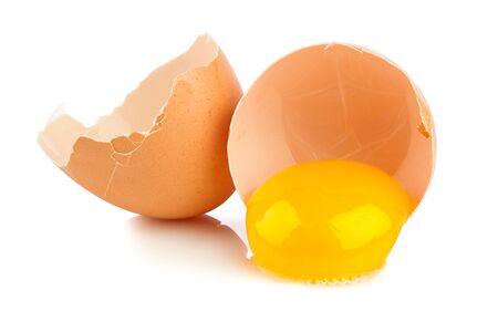 broken chicken egg on white backgroundの写真素材