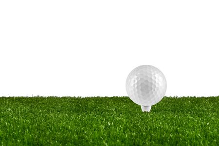 golf  ball on tee on grasの写真素材