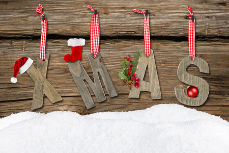 xmas letters with snow on wooden backgroundの写真素材
