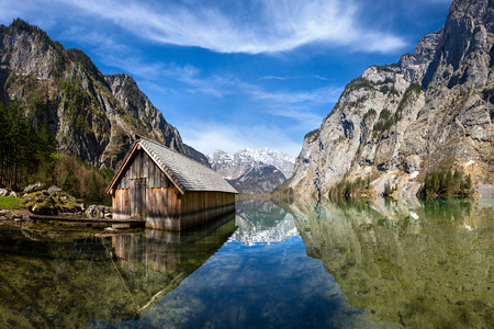 wooden house at lake in the mountainsの写真素材